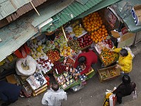  Looking down at a fruit vendor from the escalators