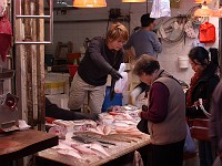  Customers purchasing fresh fish from a street vendor