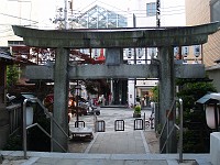  Ancient shinto gate leads directly out of the shrine into super-modern shopping center.