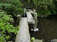  A stone bridge through some gardens.