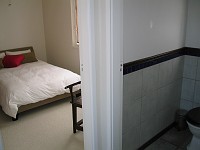  Standing at end of hallway looking in guest bedroom on left, toilet on right.