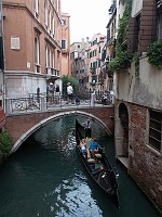  Gondola driver passes under a bridge.