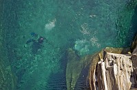  Divers visible under the clear waters of the Roman Bridge